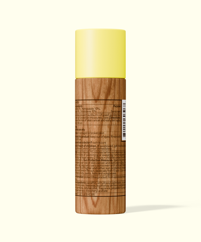 Back view of Sun Bum Paper Tube SPF 50 Sunscreen Face Stick with wood-textured packaging and yellow cap