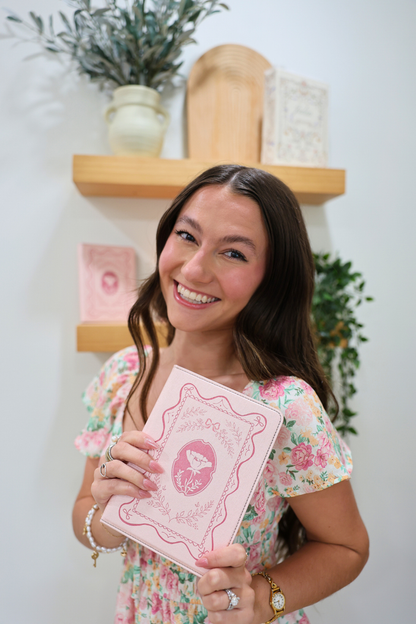 girl holding a pink kindle case