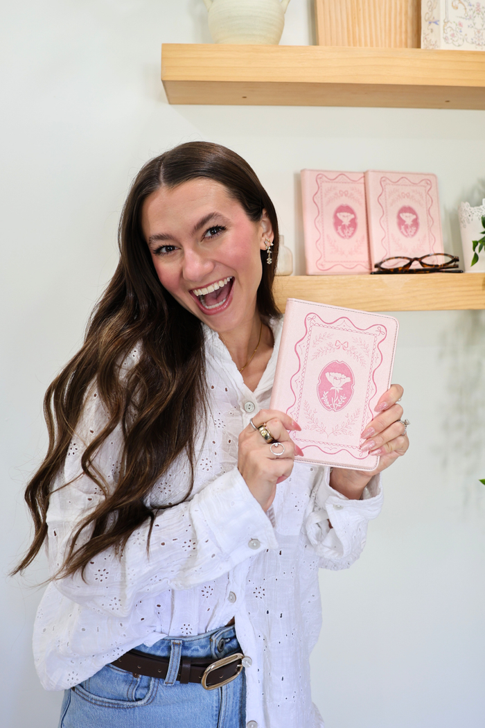 girl holding a pink kindle case