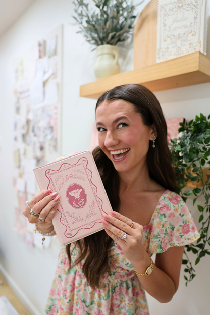 girl holding a pink kindle case