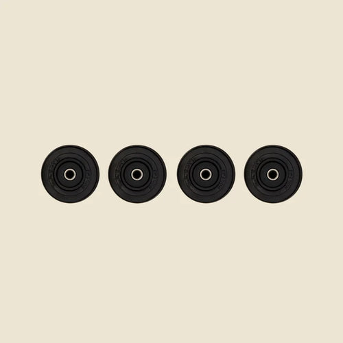 Set of 4 Guide Wheels for the Pilates Reformer  in front of Beige Background.