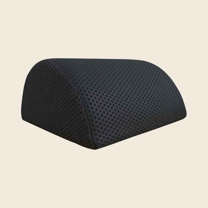 Gratz half moon Pilates pillow in black textured upholstery on a neutral background.