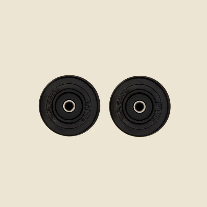 Set of 2 Castor Wheels for the Pilates Reformer in front of Beige Background.