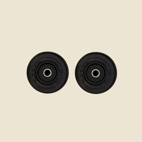 Set of 2 Castor Wheels for the Pilates Reformer in front of Beige Background.