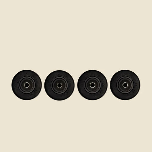 Set of 4 Carriage Reformer Wheels in front of Beige Background.