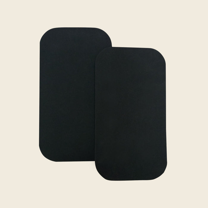 Pair of thick black rubber pads for Gratz Pilates apparatus, shown on a beige background.