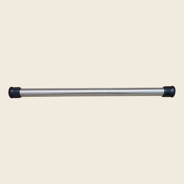 Gratz weighted stainless steel Pilates pole with black rubber end caps on beige background.