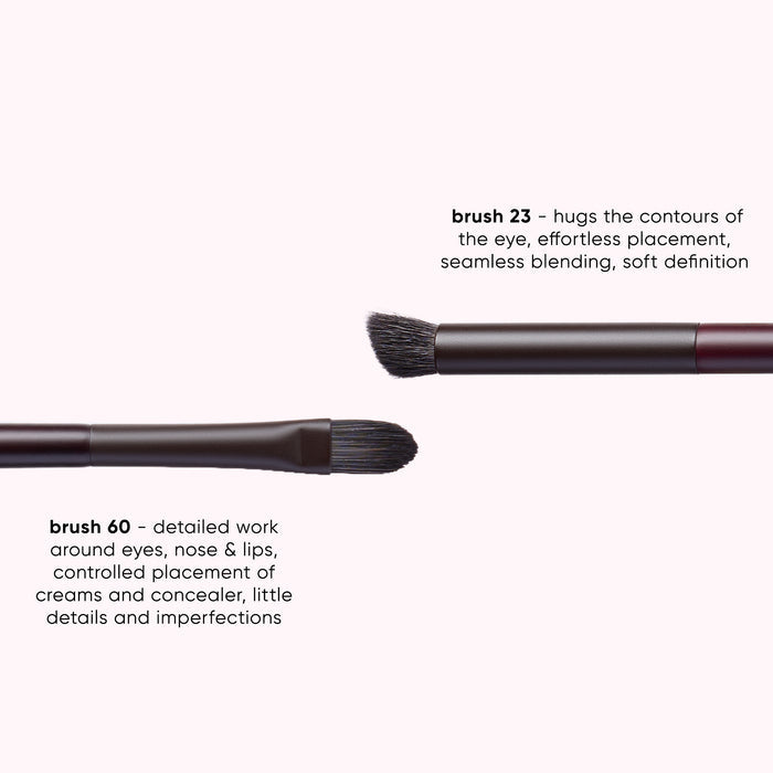 Three makeup brushes shown on a pale pink background with descriptive text labels: brush 23, brush 60, and a third brush partially visible. The brushes have dark bristles, black ferrules, and dark metallic handles.