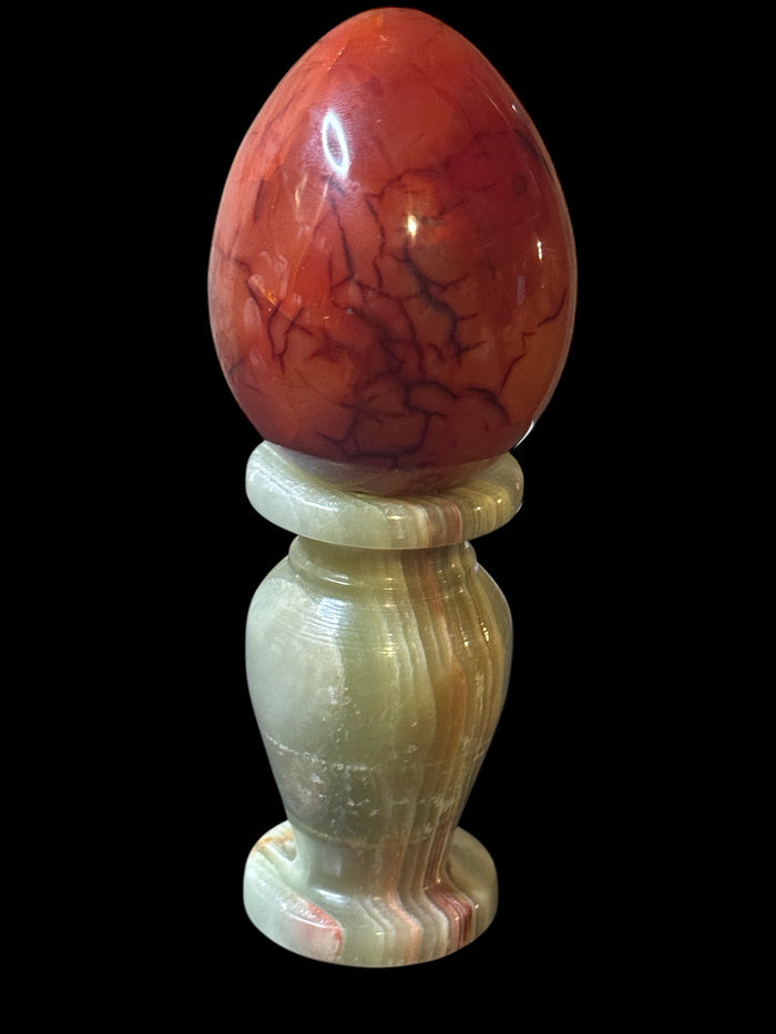 Polished Carnelian crystal egg with vibrant orange and red color, healing stone sold by weight for sacral chakra and spiritual manifestation ritual