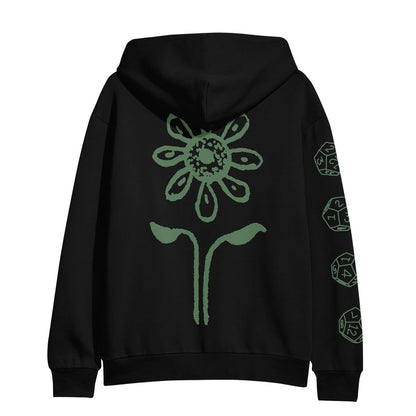 The Resilia black hoodie showcases a bold green flower and leaf design on the back, with black dice and polyhedral geometric shapes decorating the right sleeve.