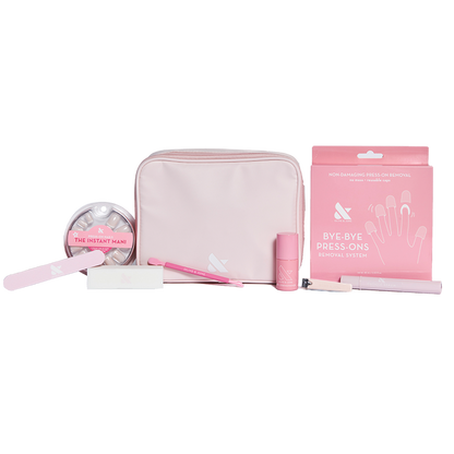 Press-On System - 4 Sets displayed with pink pouch, nail file, remover kit, brush, and nail polish for easy at-home mani care