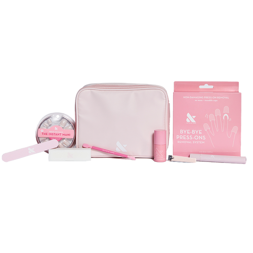 Press-On System - 4 Sets displayed with pink pouch, nail file, remover kit, brush, and nail polish for easy at-home mani care