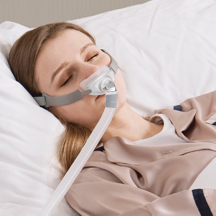 woman sleeping while wearing rio ii nasal cpap mask