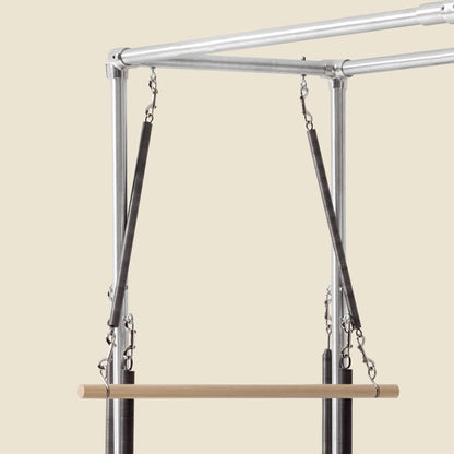 Wooden roll down bar suspended by springs and S hooks from a Cadillac frame.