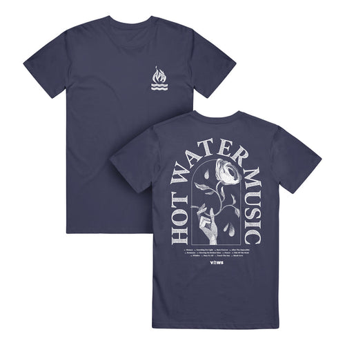 Hot Water Music navy Comfort Colors T-Shirt made of soft ring-spun cotton; features a small flame and wave logo on the chest and a large back graphic of a hand holding a wilting rose dripping water with HOT WATER MUSIC text.