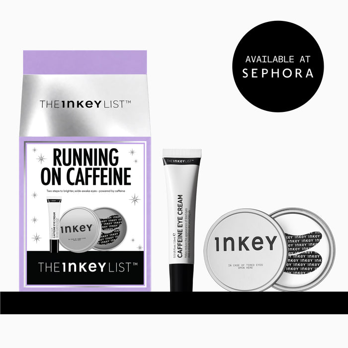 The Inkey List 'Running on Caffeine' eye cream set, featuring a purple and silver pouch, a black and white tube of caffeine eye cream, and two round silver compacts, shown on a white background with a black 'Available at Sephora' badge.