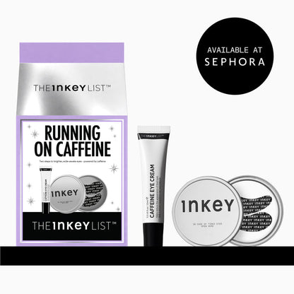 The Inkey List 'Running on Caffeine' eye cream set, featuring a purple and silver pouch, a black and white tube of caffeine eye cream, and two round silver compacts, shown on a white background with a black 'Available at Sephora' badge.