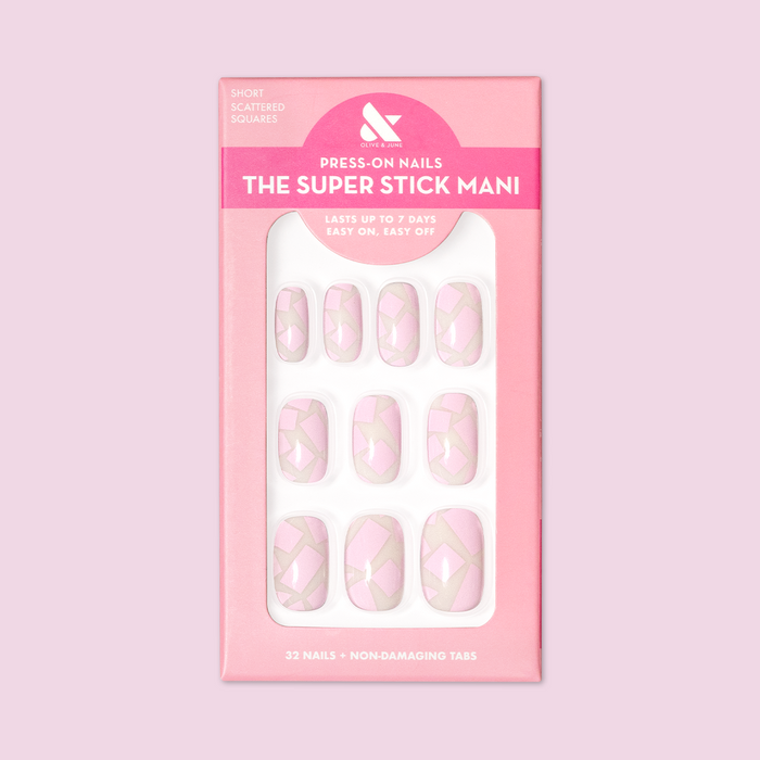Scattered Squares | Short | Squoval - Tab Press-On light pink press-on nails with geometric square pattern in packaging
