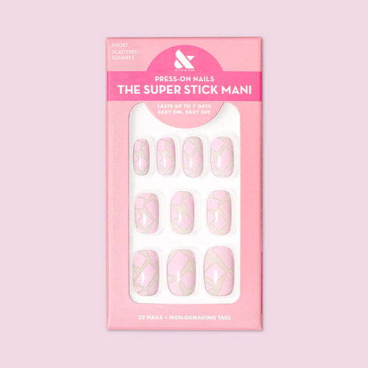 Scattered Squares | Short | Squoval - Tab Press-On light pink press-on nails with geometric square pattern in packaging