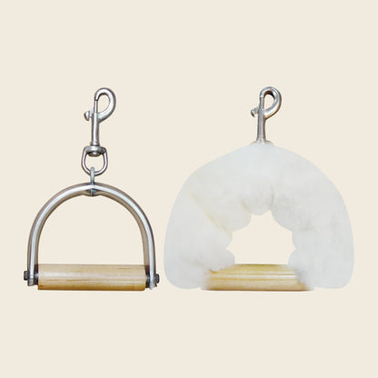 Bare Pilates reformer handle beside one wrapped in a white sheepskin cover.