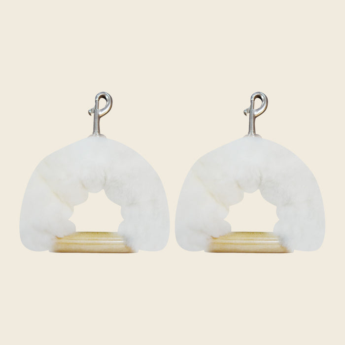 Pair of genuine sheepskin covers wrapping wooden Pilates reformer handles with metal clips.