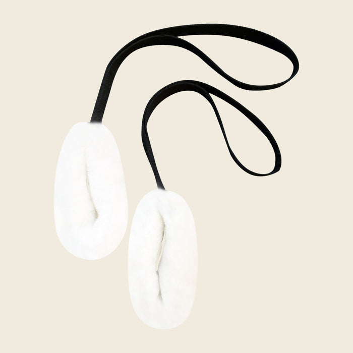 Pair of white sheepskin loops on black canvas straps for a Pilates Cadillac.
