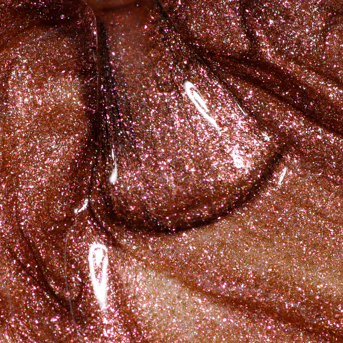 A close-up of LONDONTOWN's Shimmering Nail Highlighter - Molten shows shimmery, reddish-brown glitter in a thick, glossy liquid with light reflections.