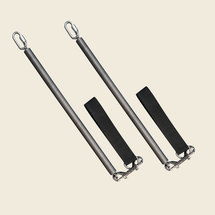 Pair of coiled Pilates springs with quick-link loops and black canvas straps with double hooks.