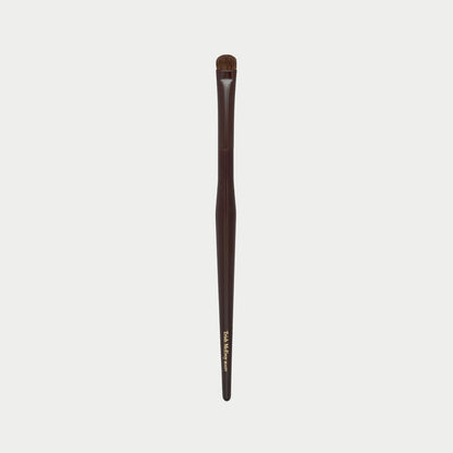 Makeup brush 54 with brown handle and black bristles on a white background