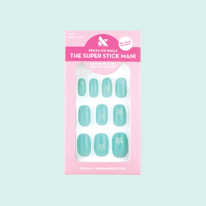 Spring Stars | Short | Squoval - Tab Press-On nails in pastel mint with turquoise star accents in packaging on light background