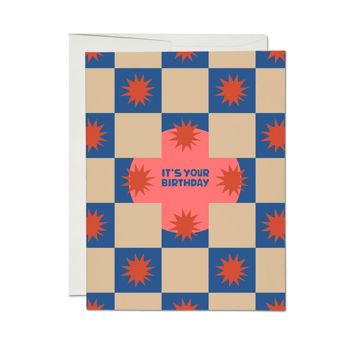 Birthday card with blue checkered design, orange bursts, and 'It's Your Birthday' text.