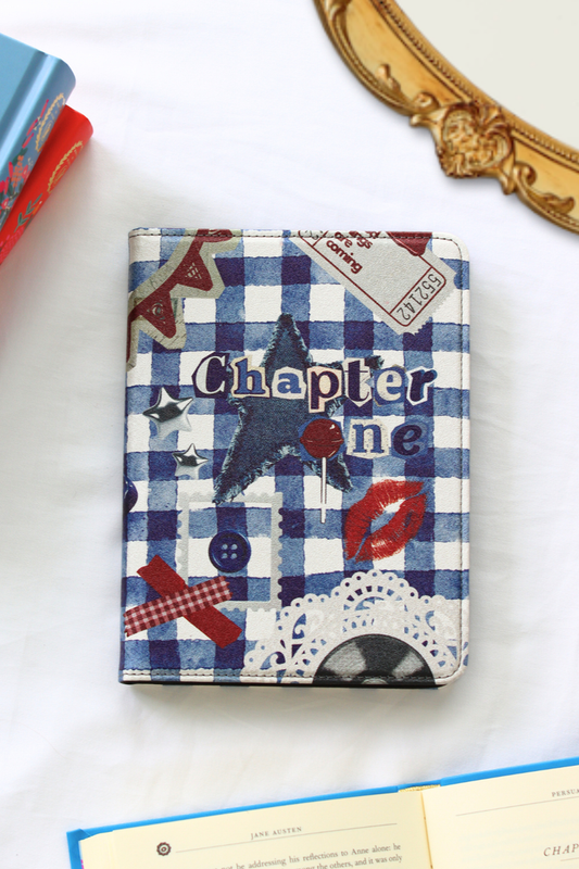 Kindle with a blue and white checkered cover featuring text and graphics on a white surface.