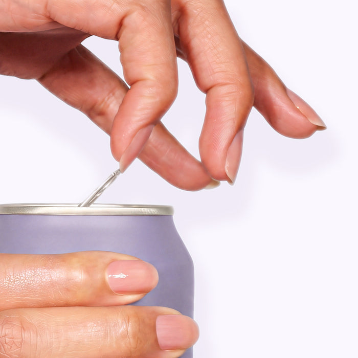 A hand opens the pull tab on a light purple aluminum can against a plain, light background—sorry, but the product description appears to only contain formatting code and no actual product details. Please provide a clear product description for LONDONTOWN Strengthening Nail Cream so I can extract SEO keywords for you.