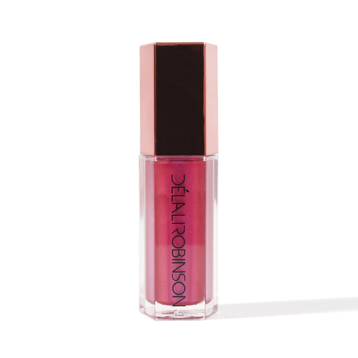 A tube of nude-colored lip gloss with a pink tint and a brown cap, labeled 'Delal Cosmetics'.
