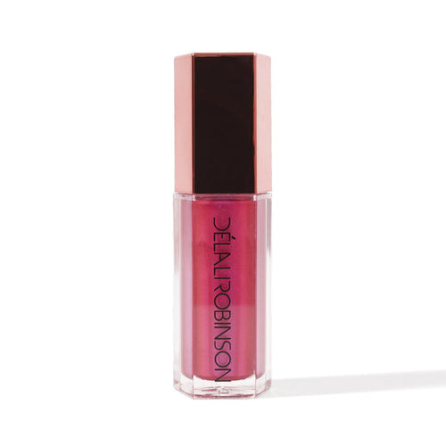 A tube of nude-colored lip gloss with a pink tint and a brown cap, labeled 'Delal Cosmetics'.