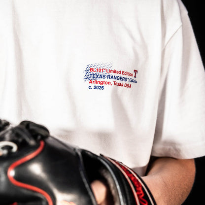 Youth model wearing white youth graphic tee with "Texas Rangers Drip" design