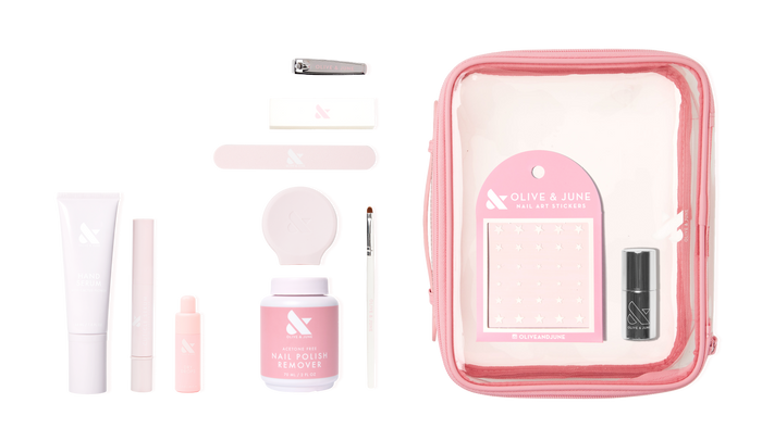 The Mani Weekender - 1 Polish kit with nail polish remover, hand serum, nail file, stickers, and tools in a clear pink pouch