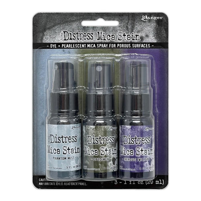 Tim Holtz - Distress Mica Stain Set - Halloween Set# 6. Tim Holtz Distress Mica Stains are a colorful elixir of pearlescent shimmer for mixed media and papercraft projects. This set includes colors Phantom Mist, Specimen and Ominous Twilight. Available at Embellish Away located in Bowmanville Ontario Canada.