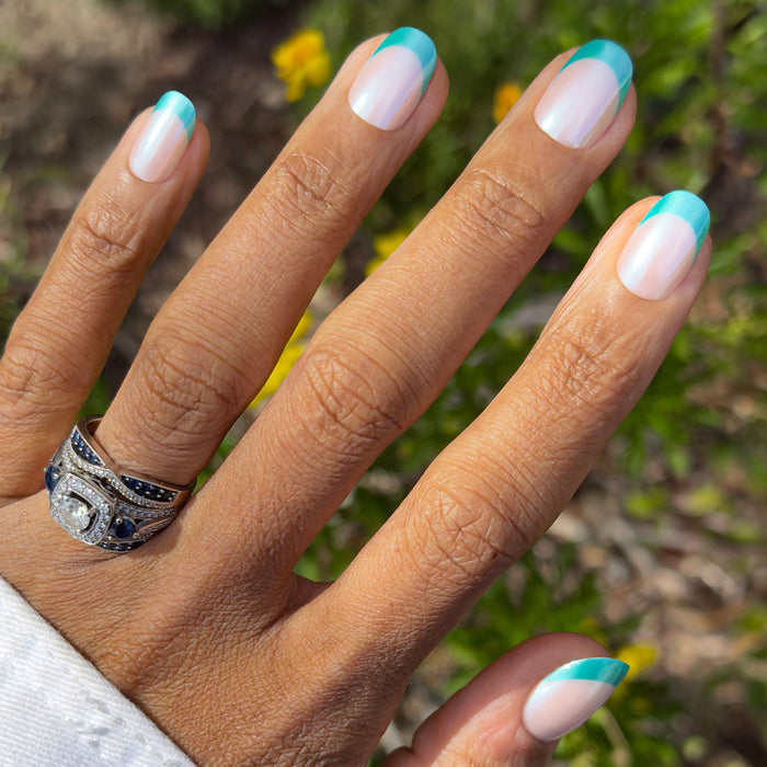 Turquoise Chrome | Short | Round - Tab Press-On nails with sheer base and turquoise chrome french tips for easy at-home mani