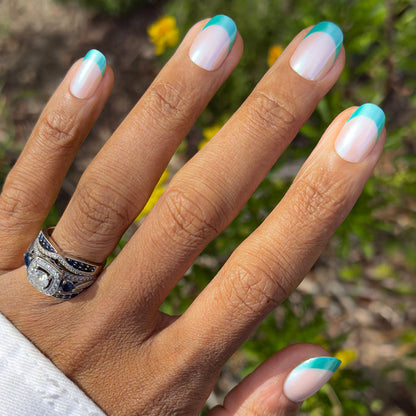 Turquoise Chrome | Short | Round - Tab Press-On nails with sheer base and turquoise chrome french tips for easy at-home mani