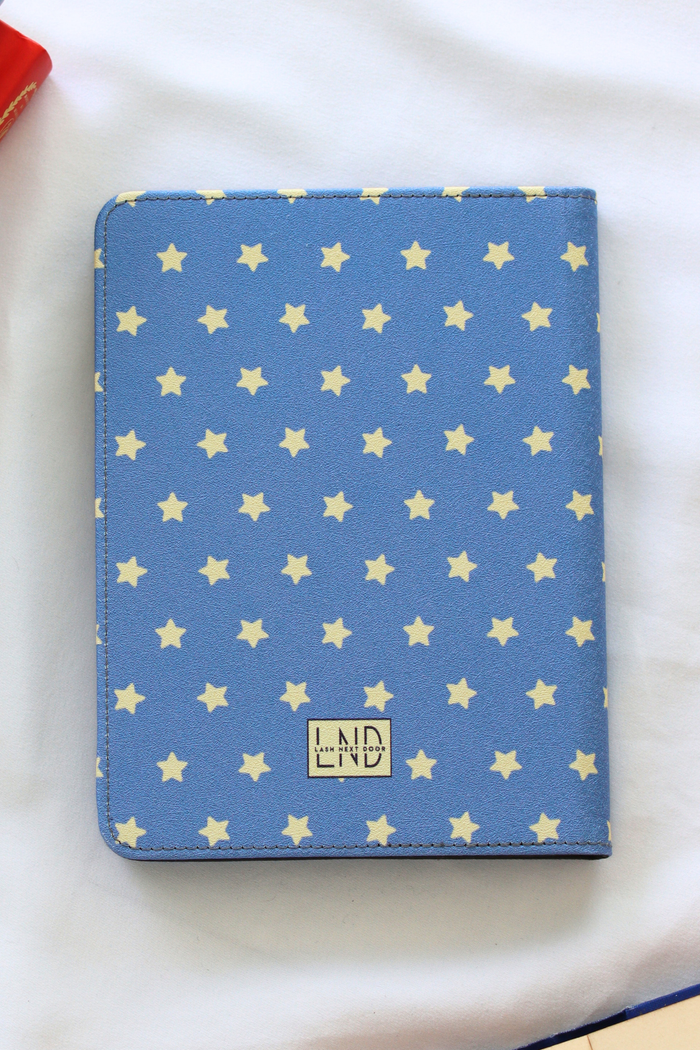 Blue kindle case with star pattern on a white background