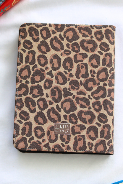 Leopard print kindle with a visible brand logo on a white surface