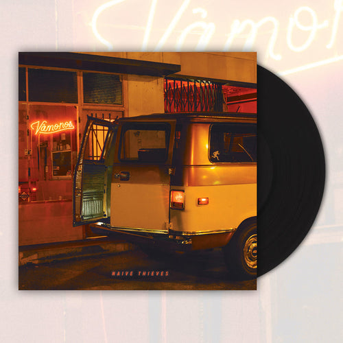 A classic black vinyl peeks out of a jacket with an orange filter on the picture. The image includes a broken down white van that's trunk is half open in front of a store with "Vamonos" written in light up letters. The words "Naive Thieves" are at the bottom of the vinyl in orange.