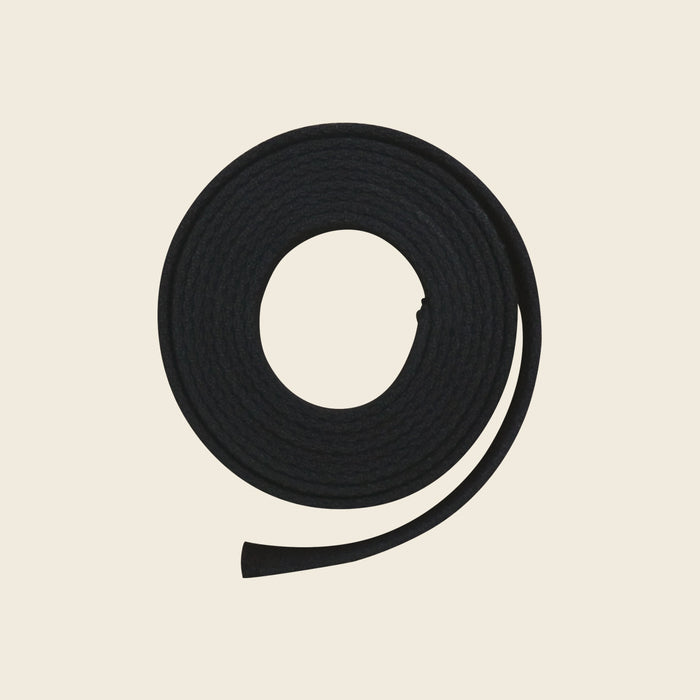 Black 90-inch webbing belly strap for Pilates Cadillac, coiled on a neutral background.