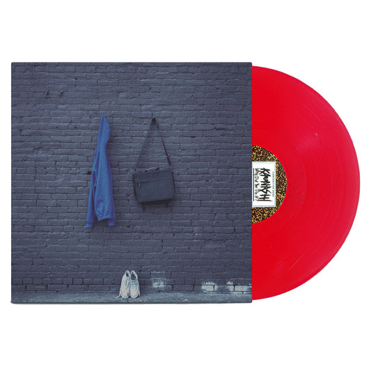 A red vinyl LP slides out of a gray brick wall-themed album cover with a blue jacket, black bag, and white sneakers—ideal for Kaonashi fans looking for alternative shipping options.