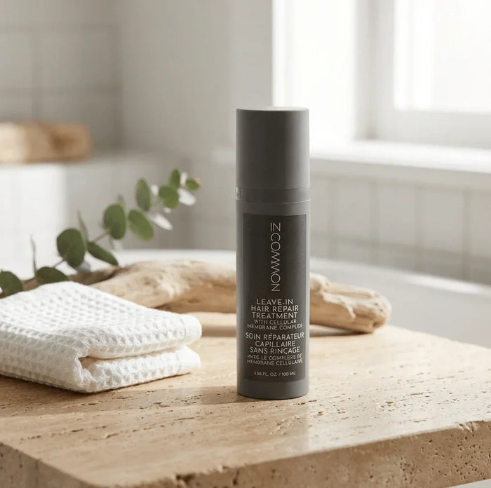 Leave-in hair repair treatment bottle with cellular membrane complex on bathroom counter