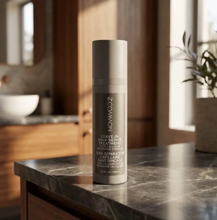 Leave-in hair repair treatment bottle with cellular membrane complex on bathroom counter